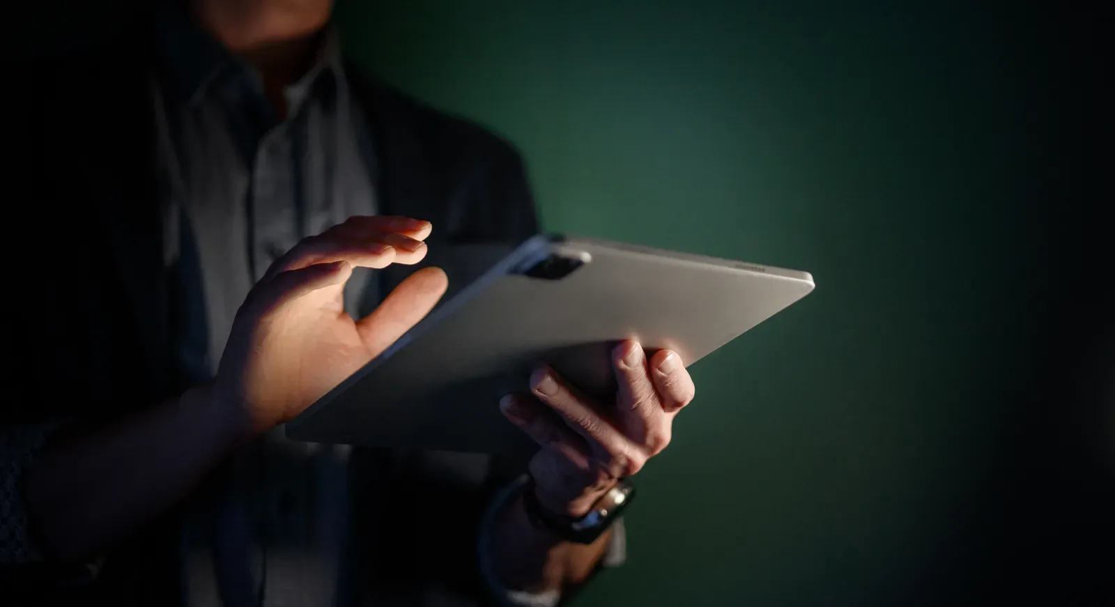 Banker reviewing flagged activity on a tablet