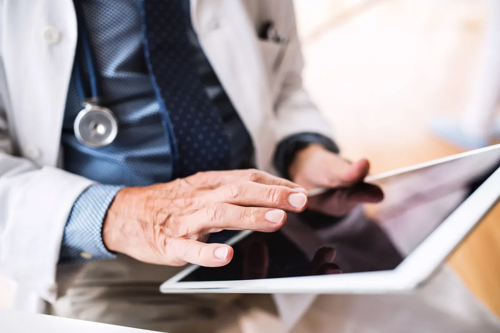 Doctor reviewing records on a tablet